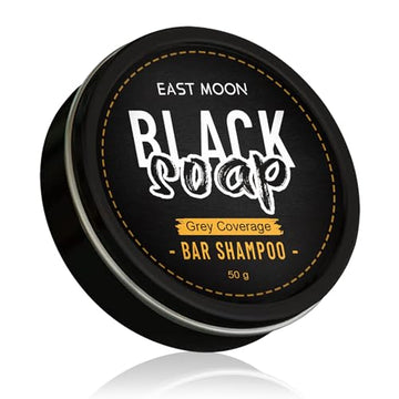 Black soap bar shampoo by East Moon, natural black soap for hair cleansing, shown as a dark soap bar on a white background.