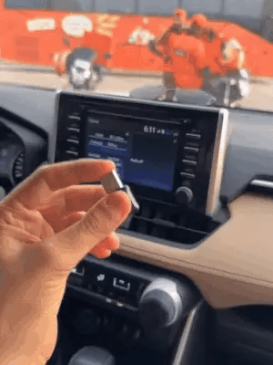 Wireless Car Play Adapter by My Store connected to a car dashboard showing smartphone integration and screen interface.