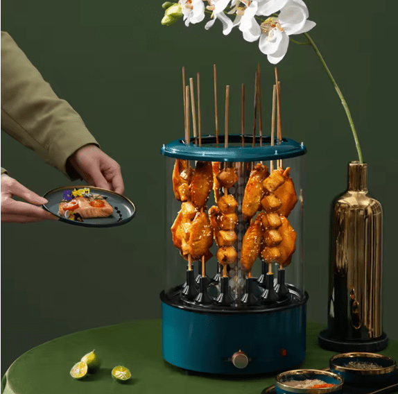 Bazaar E Arab electric rotating grill with stainless steel cooking surface and rotating mechanism for even grilling.